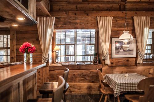 a dining room with a table and a window at Hotel Schönegg in Wengen