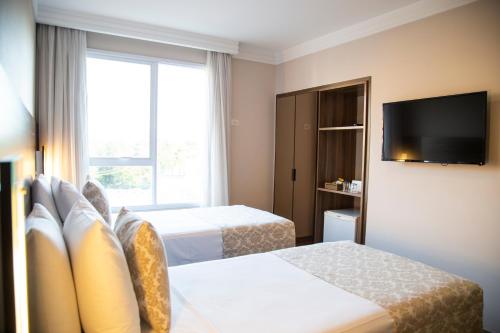 Hotel Florençaにあるベッド