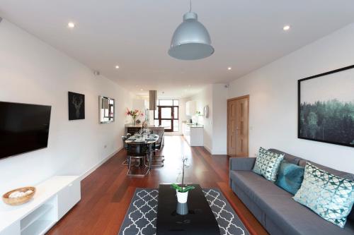 a living room with a couch and a table at Hampden Apartments - The Charles in Windsor