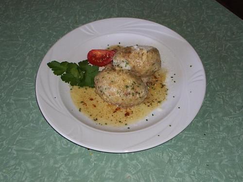 a plate of food with meatballs and a strawberry on it at Gasthaus Oberkirn in Schenna