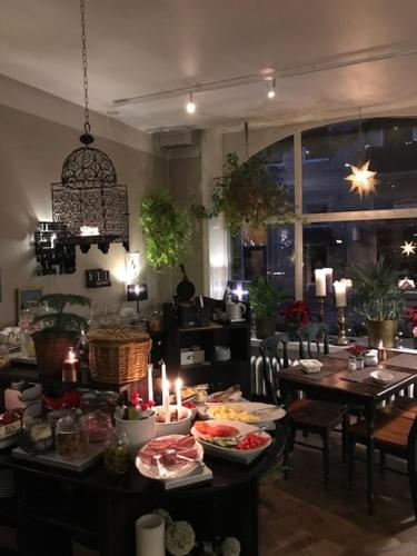 a dining room with a table with candles on it at Hotel Lilton in Ängelholm