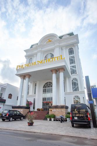 a large white building with a sign on it at Phung Hung Boutique Hotel in Phu Quoc