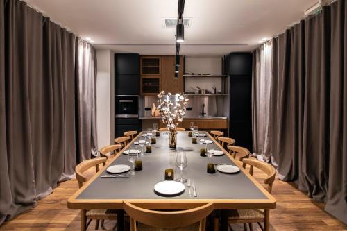a dining room with a long table and chairs at Ergon House Athens in Athens