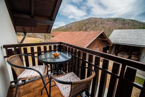 a balcony with two chairs and a table on it at Farm Stay Žagar in Mozirje