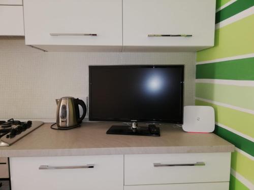 a flat screen tv sitting on top of a kitchen counter at Stella di Mare in La Spezia