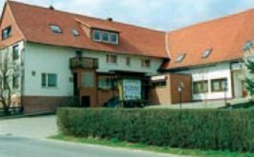 a large house with an orange roof at Pension Am Thieberg in Landolfshausen