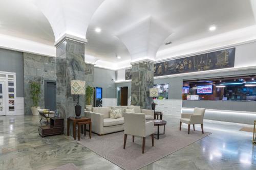 a living room with a couch and tables and chairs at Hotel Bahía de Vigo in Vigo
