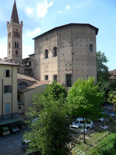 an old building with a tower and a church at Ospitalità San Tommaso d'Aquino in Bologna
