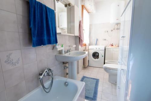 a bathroom with a sink and a toilet and a tub at Casa Paola in Marina di Campo