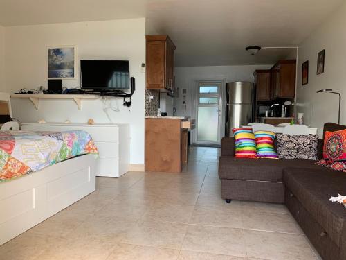 a living room with a couch and a kitchen at Obera Beach #105 in Freeport