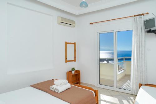 a bedroom with a bed with a view of the ocean at Villa Margarita in Limenaria
