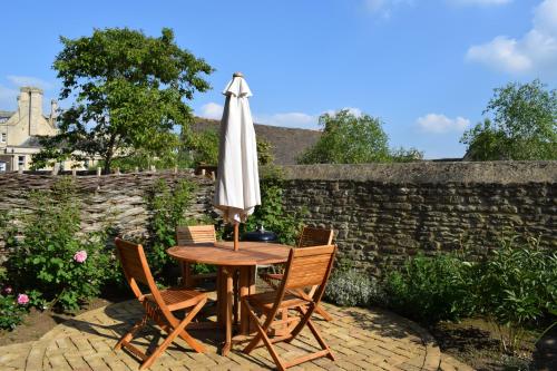 a table and chairs with an umbrella on a patio at Oundle Bespoke Apartments in Oundle