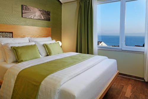 a bedroom with a large bed with a large window at Boutique Hotel Bol in Bol