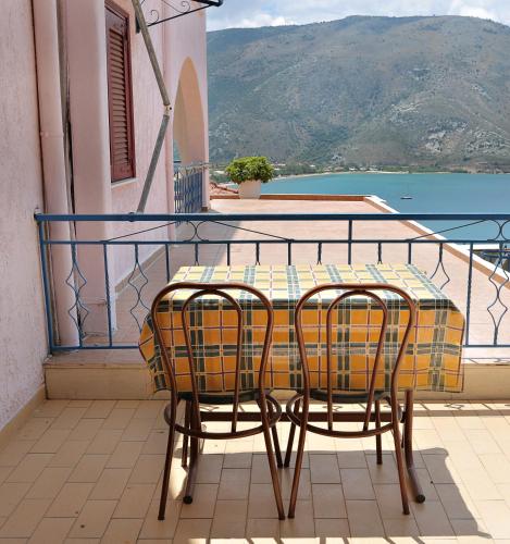 a table and two chairs sitting on a balcony at Panorama Plataria Ionio Studios&Apartments in Plataria