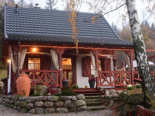 a wooden house with a porch and a porch at Domek w Karkonoszach in Przesieka