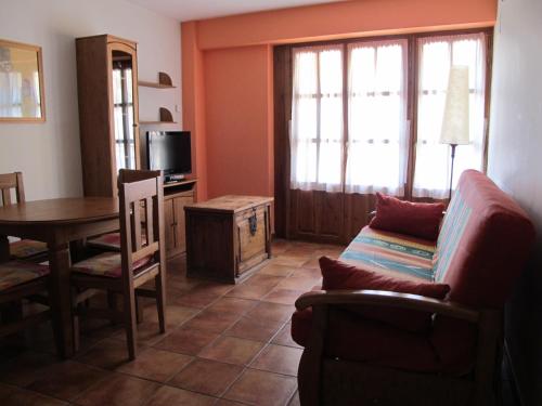 a living room with a couch and a table at Apartamentos Casa Español in Broto