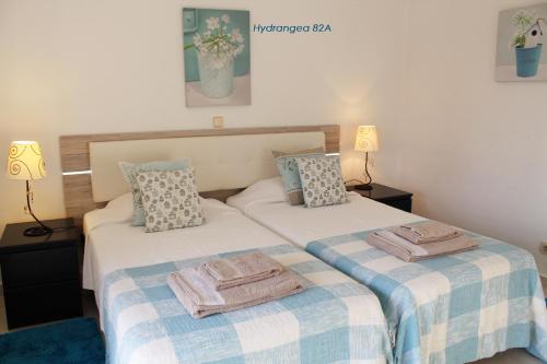 two beds sitting next to each other in a bedroom at Apartamentos São Rafael - Albufeira, Algarve in Albufeira