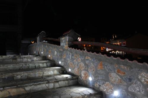 a set of stone stairs at night with lights at Anesis Suites in Palaios Agios Athanasios