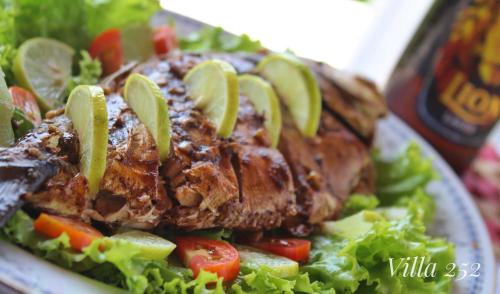 a plate of food with a salad with meat and vegetables at Villa 252 Kosgoda in Kosgoda