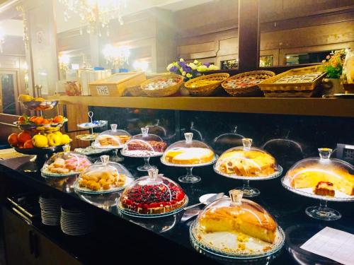 a buffet line with many different types of food at Hotel Mythos in Milan