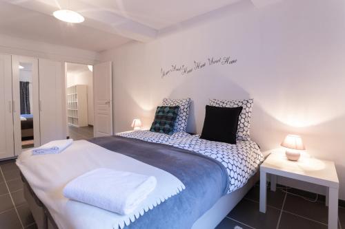 a bedroom with a large bed with blue and white sheets at Appartement en plein centre ville in Apt