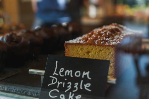 a piece of cake on a table with a sign at The Highdown – Brunning and Price in Worthing