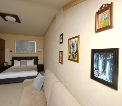 a hotel room with a bed and a couch at Shato Luxe in Odesa