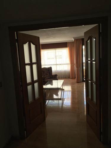 an open door into a living room with a couch at Apartamento en Alicante, Plaza de España, zona Mercado, AA in Alicante