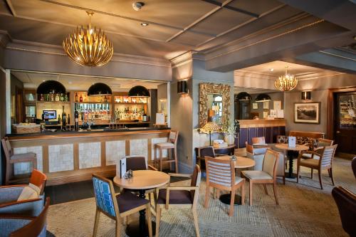 a restaurant with tables and chairs and a bar at Royal Oak Hotel in Betws-y-coed