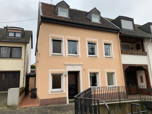a brown house with a black roof at Ferien Haus am Bach in Föhren