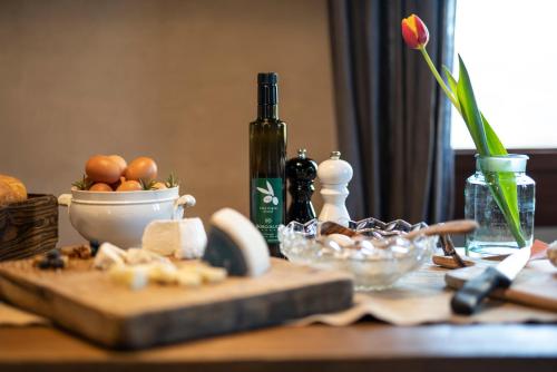 a table with a bottle of wine and a bowl of food at Foresteria San Rocco Borgoluce in Susegana