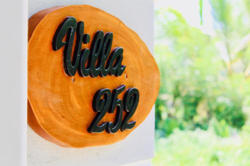 a wooden sign on the side of a building at Villa 252 Kosgoda in Kosgoda