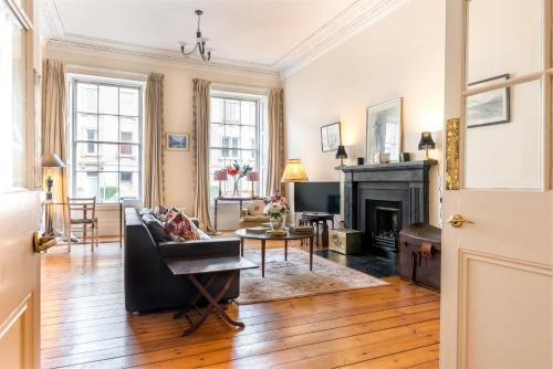 a living room with a couch and a fireplace at GRAND & SPACIOUS CENTRAL APT WITH WiFi in Edinburgh