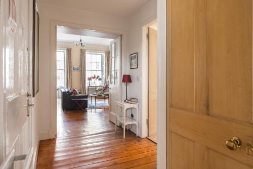 an open door to a hallway with a living room at GRAND & SPACIOUS CENTRAL APT WITH WiFi in Edinburgh