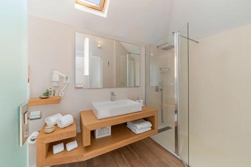 a bathroom with a sink and a mirror at NEW! Villa Alvinho| Lifestyle&Nature | Heated Pool in Funchal