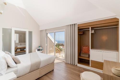 a bedroom with a large bed and a large window at NEW! Villa Alvinho| Lifestyle&Nature | Heated Pool in Funchal