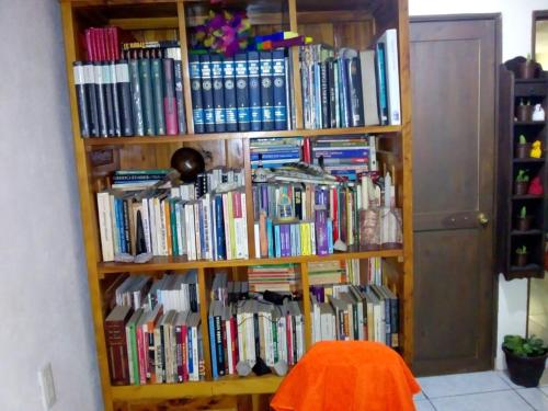 a book shelf filled with lots of books at Recámara rústica in Mexico City