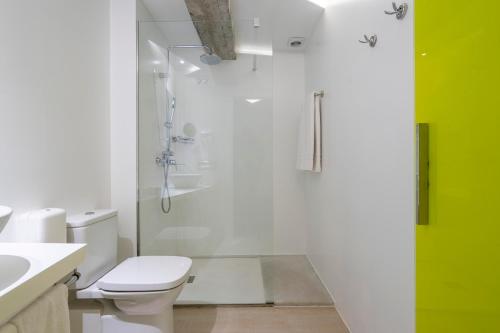 a bathroom with a shower and a toilet and a sink at Atarazanas Málaga Boutique Hotel in Málaga