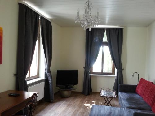 a living room with a couch and two windows at Bernkastler Graben in Bernkastel-Kues