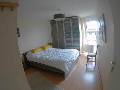 ベルク・シュル・メールにあるVilla du chemin des Anglaisのベッドルーム1室(ベッド1台、椅子、窓付)