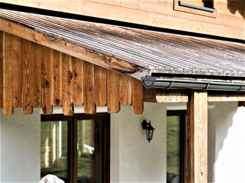 a building with a wooden roof with a light on it at Feriendorf X-Alp Lodges Ötztal in Sautens