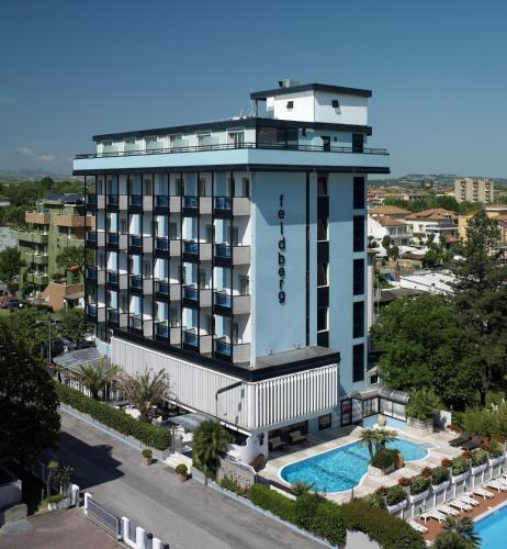 a hotel with a swimming pool in front of a building at Hotel Feldberg in Riccione