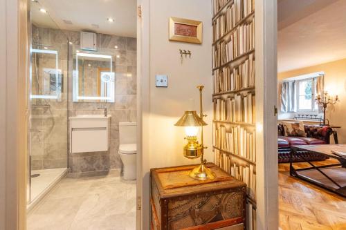 a bathroom with a walk in shower and a toilet at Old town Brewery Apartment in Edinburgh