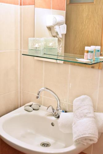 a bathroom with a sink and a mirror at Evia Studios in Loutra Edipsou