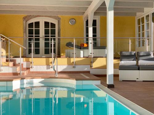 a house with a swimming pool and a patio at Ferienwohnung Schultheiß in Remptendorf