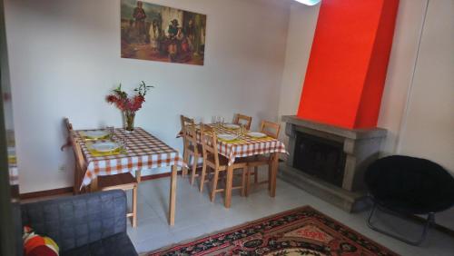 a dining room with a table and a fireplace at Arouca à Varanda in Arouca