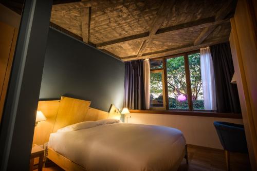 a bedroom with a large bed and a window at Juvarrahouse Luxury Apartments in Turin