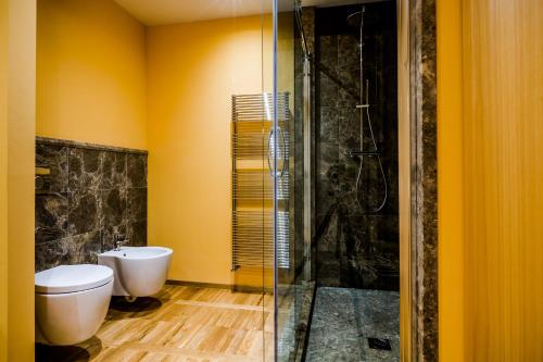 a bathroom with a toilet and a glass shower at Juvarrahouse Luxury Apartments in Turin