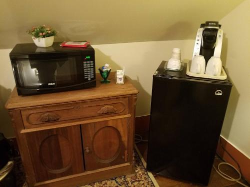 a microwave sitting on top of a small refrigerator at Lilly Pad in Cedarburg