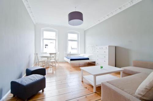 a living room with a couch and a table at Magnificent turn of century flat (legal) in Berlin